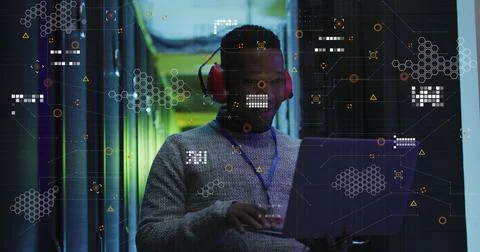 Image of data processing over african american male engineer using laptop at Stock Photos