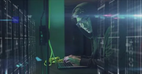 Image of data processing over asian male hacker in hoodie with laptop by Foto stock