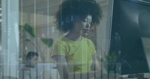 Image of data processing over biracial businesswoman using computer Stock Photos