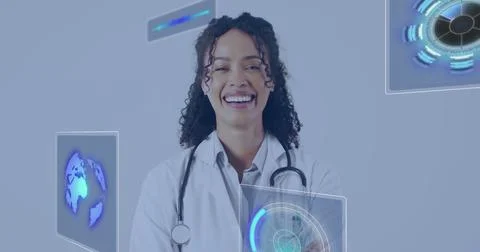 Image of data processing over biracial female doctor smiling Stock Photos