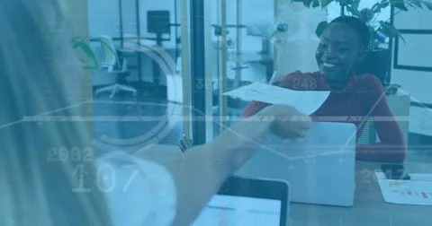 Image of data processing over caucasian woman passing a document to another.. Stock Photos