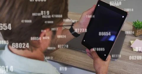 Image of data processing over caucasian man using tablet Stockfoto's