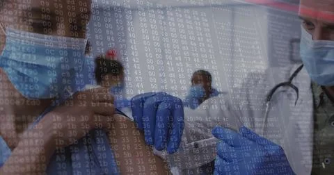 Image of data processing over caucasian male doctor vaccinating patient Stockfoto's