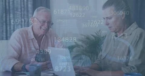 Image of data processing over caucasian senior couple using laptop Foto stock