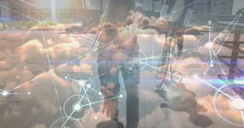 Image of data processing over clouds and biracial man skateboarding Stock Photos