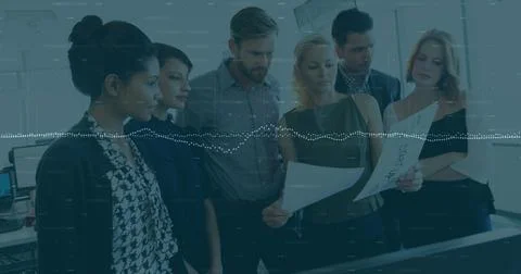 Image of data processing over diverse team of colleagues reading documents Foto stock