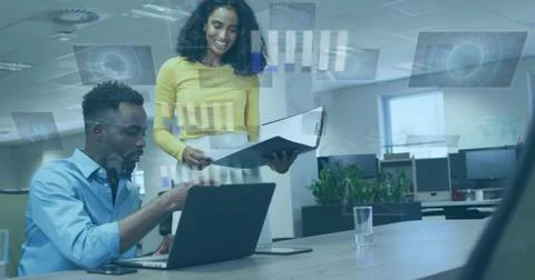 Image of data processing over diverse man and woman discussing over laptop at Stock Photos