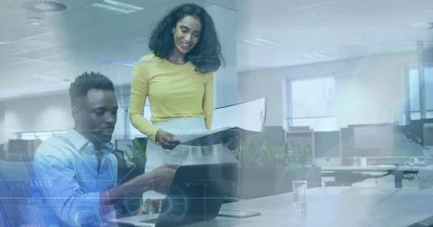 Image of data processing over diverse man and woman discussing over laptop at Stock Photos