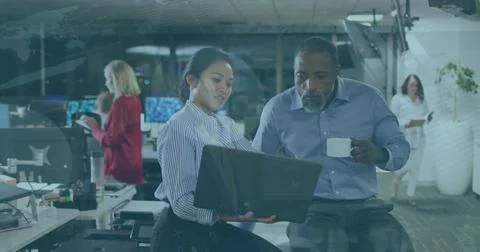 Image of data processing over diverse business people using laptop in office Foto stock