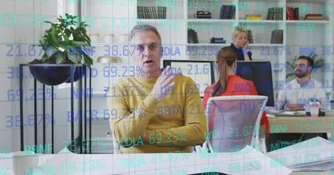 Image of data processing over diverse business people in office Fotos de archivo