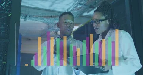 Image of data processing over diverse male and female engineers discussing at Foto stock