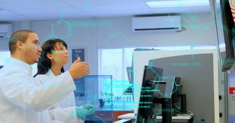 Image of data processing over diverse male and female scientists discussing at Foto stock