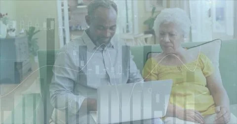 Image of data processing over diverse senior couple using laptop Stock Photos