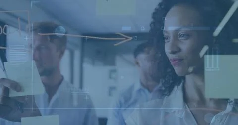 Image of data processing over diverse business people taking notes Stock Photos