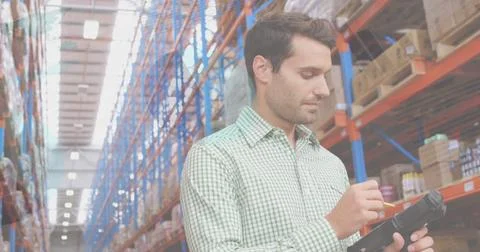 Image of data processing over man working in warehouse Foto stock