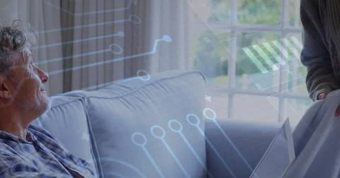 Image of data processing over senior caucasian couple smiling at home Stock Photos