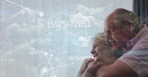 Image of data processing over senior caucasian couple smiling Stock Photos
