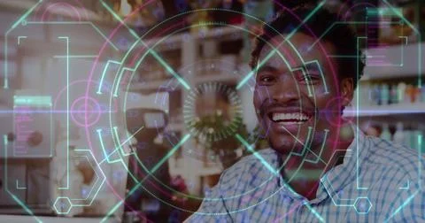 Image of data processing over smiling african american man in cafe Stock Photos