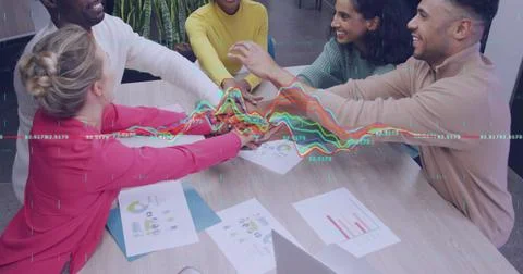 Image of data processing over team of diverse colleagues stacking their hands 库存照片