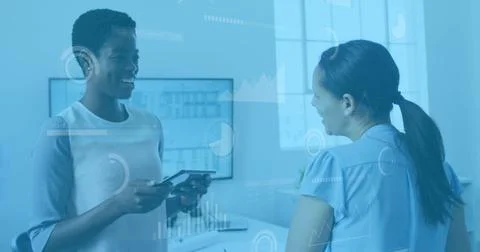 Image of data processing over two diverse women discussing over a digital t.. 写真素材