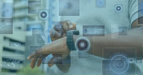 Image of data processing on screens over biracial man checking smartwatch Stock Photos
