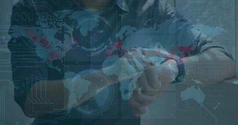 Image of data processing on screens over caucasian man checking smartwatch Foto stock