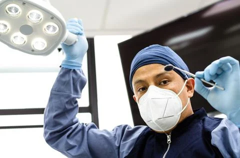 Image of a dentist with dentistry tools in hands. Stock Photos