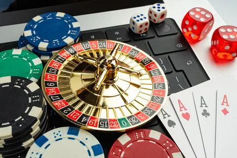 Image depicts a gambling scene, centered around a roulette wheel and playin.. Stock Photos