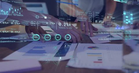 Image of diagrams and data processing over diverse colleagues discussing work in Stock Photos