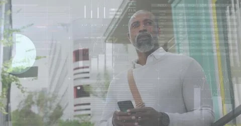 Image of diagrams and data processing over african american man using smartphone Stock Photos