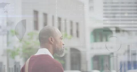 Image of diagrams and data processing over african american man walking in city Stock Photos