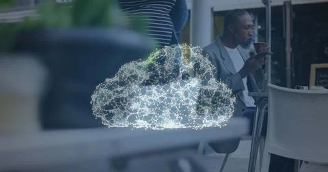 Image of digital cloud icon over man having coffee and talking on smartphone Stock Photos