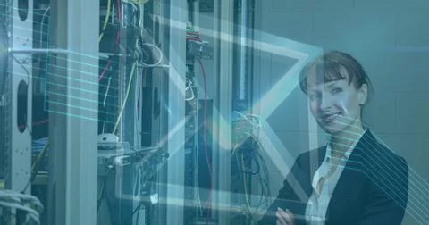 Image of digital envelope icon over woman in tech room with computer servers Stock Photos
