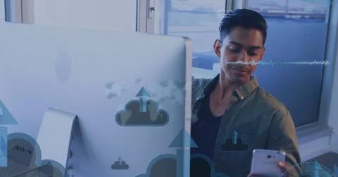 Image of digital icons and data processing over man using computer Foto stock