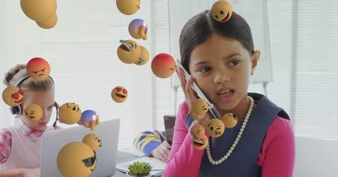 Image of digital interface with emoji icons floating over children using Stock Photos