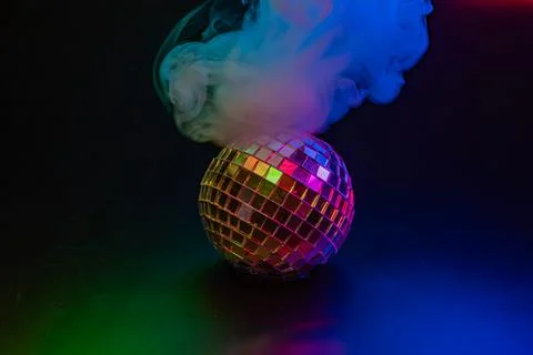 Image of a disco ball with multicolored reflections under a vapor plume, sy.. Stock Photos