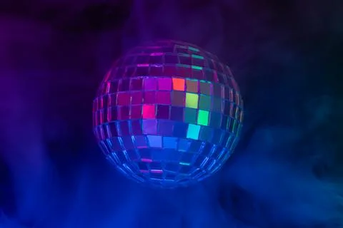 Image of a disco ball spinning, generating a vibrant and lively sparkling e.. Stock Photos