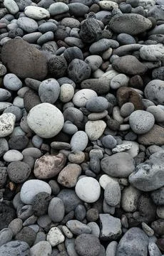 The image displays a collection of rounded rocks in shades of grey and white, Stock Photos