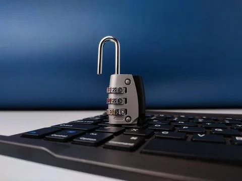 The image displays combination padlockresting on a computer keyboard, symbo.. Stock Photos