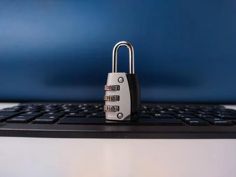 The image displays combination padlockresting on a computer keyboard, symbo.. Stock Photos