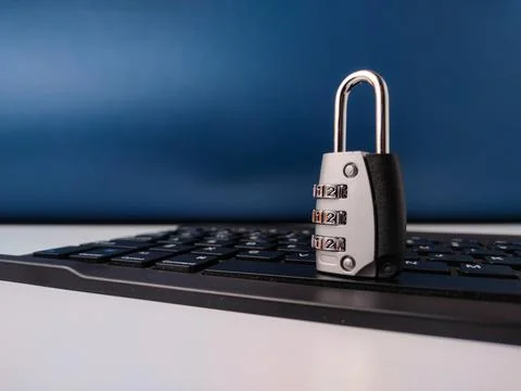 The image displays combination padlockresting on a computer keyboard, symbo.. Stock Photos