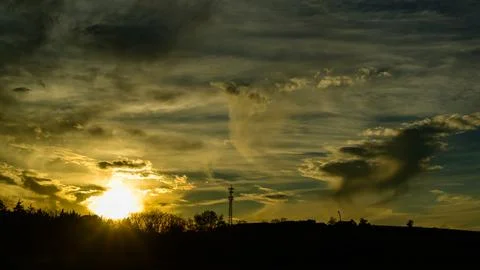 The image displays crepuscular rays, which are bands of light fanning out f.. Stock Photos