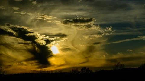 The image displays crepuscular rays, which are bands of light fanning out f.. Stock Photos