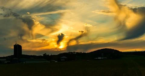 The image displays crepuscular rays, which are bands of light fanning out f.. Stock Photos