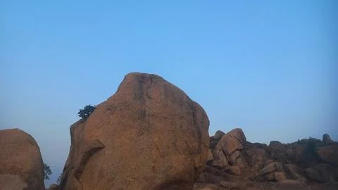 The image displays the distinctive boulder landscape found in Hampi, India.  Stock Photos