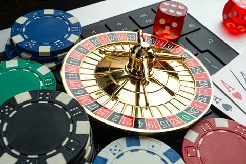 Image displays gambling items like roulette wheel, poker chips, and playing.. Stock Photos