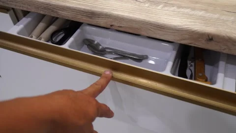 The image displays an open kitchen drawer filled with various utensils and cooki 스톡 동영상 344093597