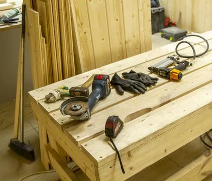 The image displays various woodworking tools laid out on a wooden workbench.. Stock Photos