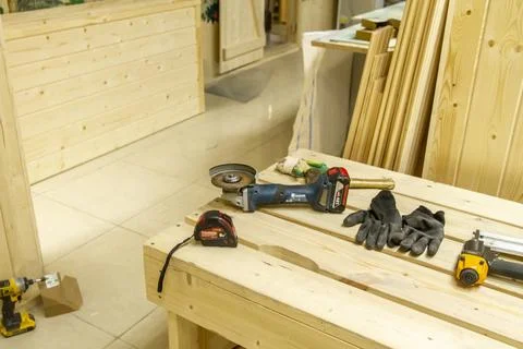 The image displays various woodworking tools laid out on a wooden workbench.. Stock Photos