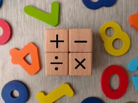 The image displays wooden cubes with basic mathematical operation symbols Stock Photos